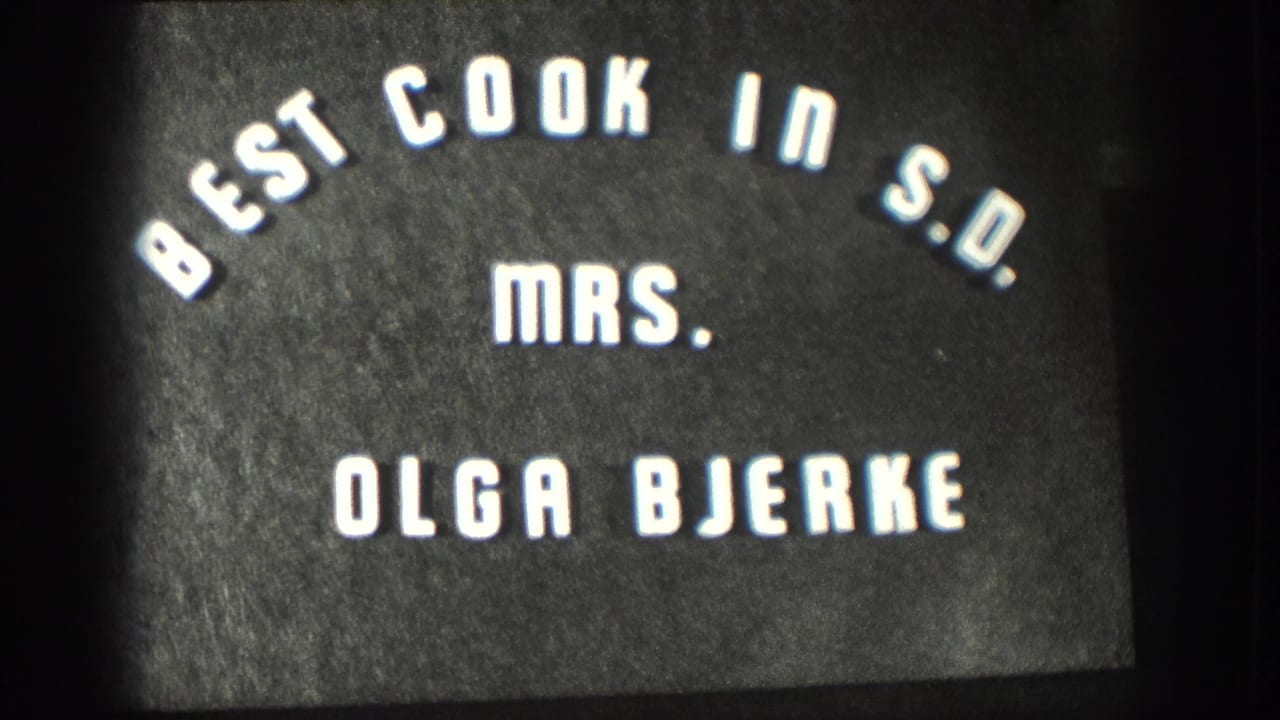Title card naming Mrs. Olga Bjerke beneath arched Best Cook in S.D. text.