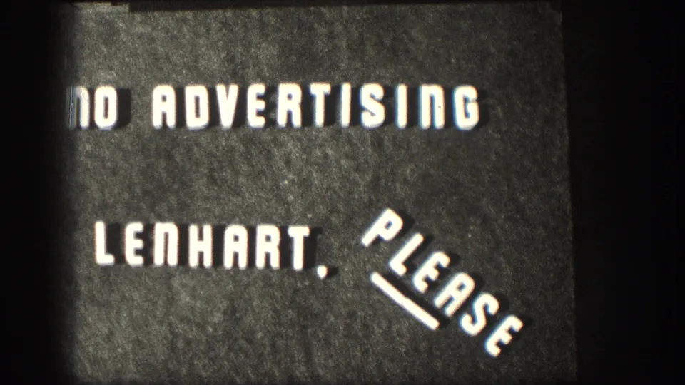 Close view of a dark spliced title card repeating the NO ADVERTISING LENHART, PLEASE message with visible film grain and edge shadow.