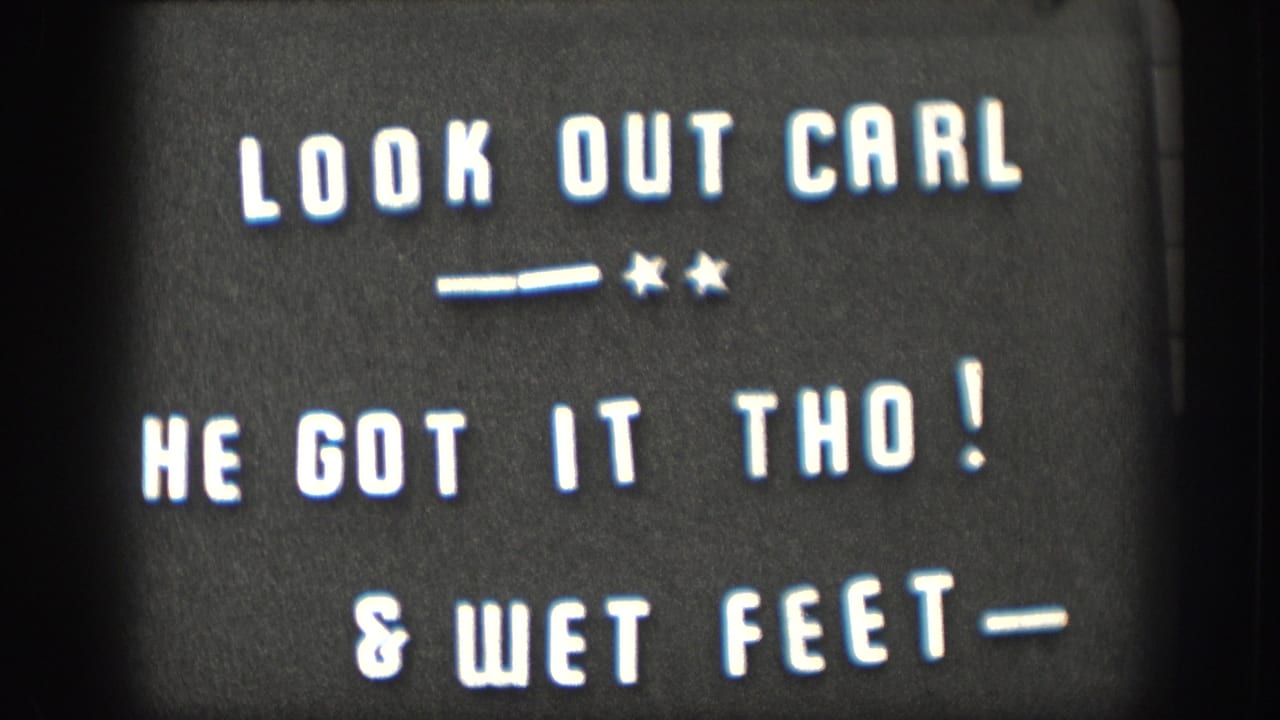 1958 home-movie title card with white letters on black reading LOOK OUT CARL, HE GOT IT THO!, and & WET FEET.