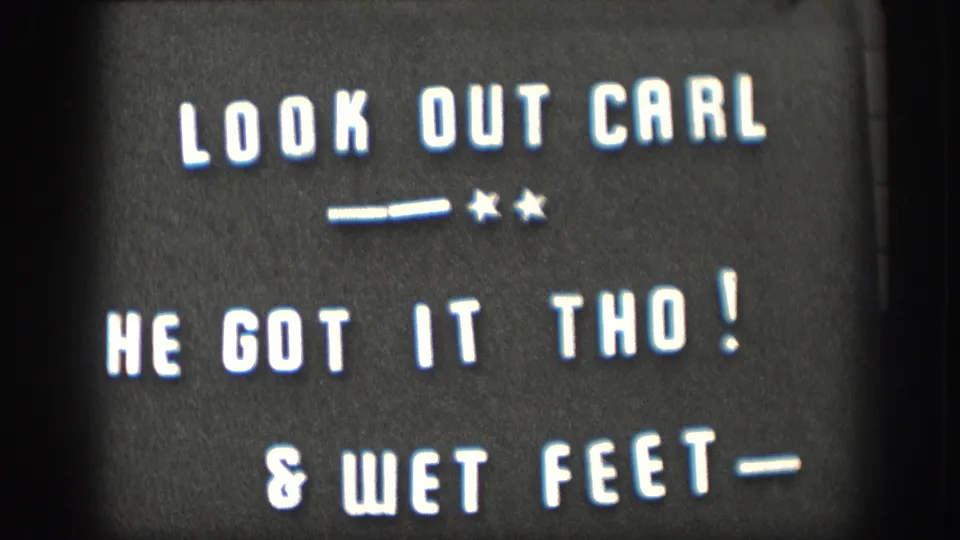 1958 home-movie title card with white letters on black reading LOOK OUT CARL, HE GOT IT THO!, and & WET FEET.