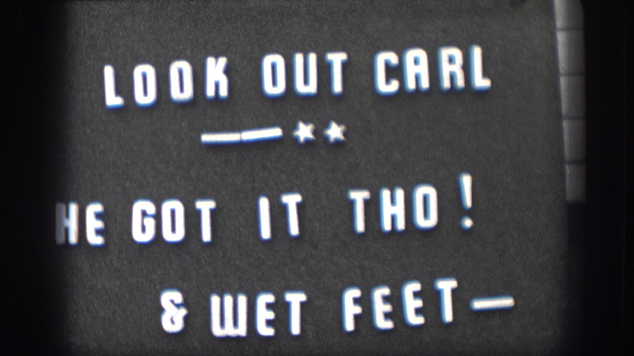 1958 home-movie frame showing the white-on-black title card about Carl, catching it, and wet feet.