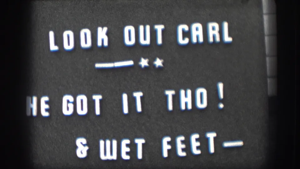 1958 home-movie frame showing the white-on-black title card about Carl, catching it, and wet feet.