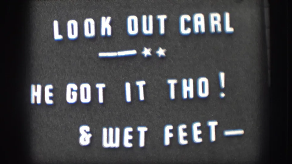 Home-movie title card in white block letters references Carl, a catch, and wet feet before the pond scene.