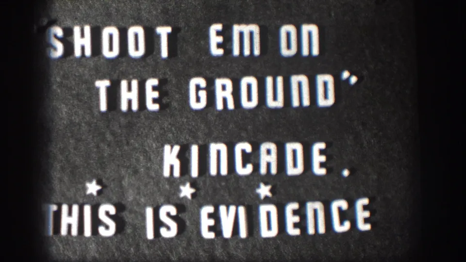 1958 Kansas 8mm frame of a dark title card with white block letters, star marks, and partially cropped wording.