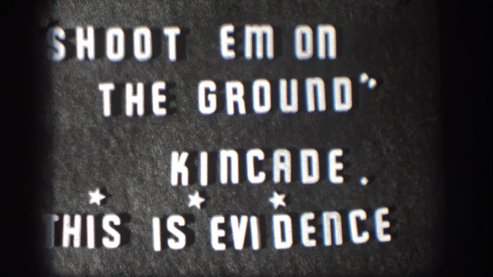 Kansas 1958 home-movie title card with high-contrast white lettering on a dark card and visible 8mm grain.