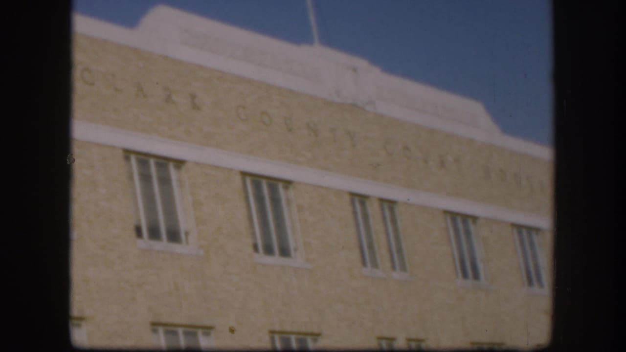 Pale brick courthouse facade with engraved Clark County Court House lettering and rows of windows.