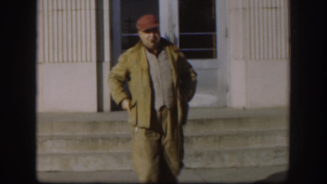 The Kansas 1958 frame shows the man closer to the camera, standing before the building facade with one hand near his pocket.