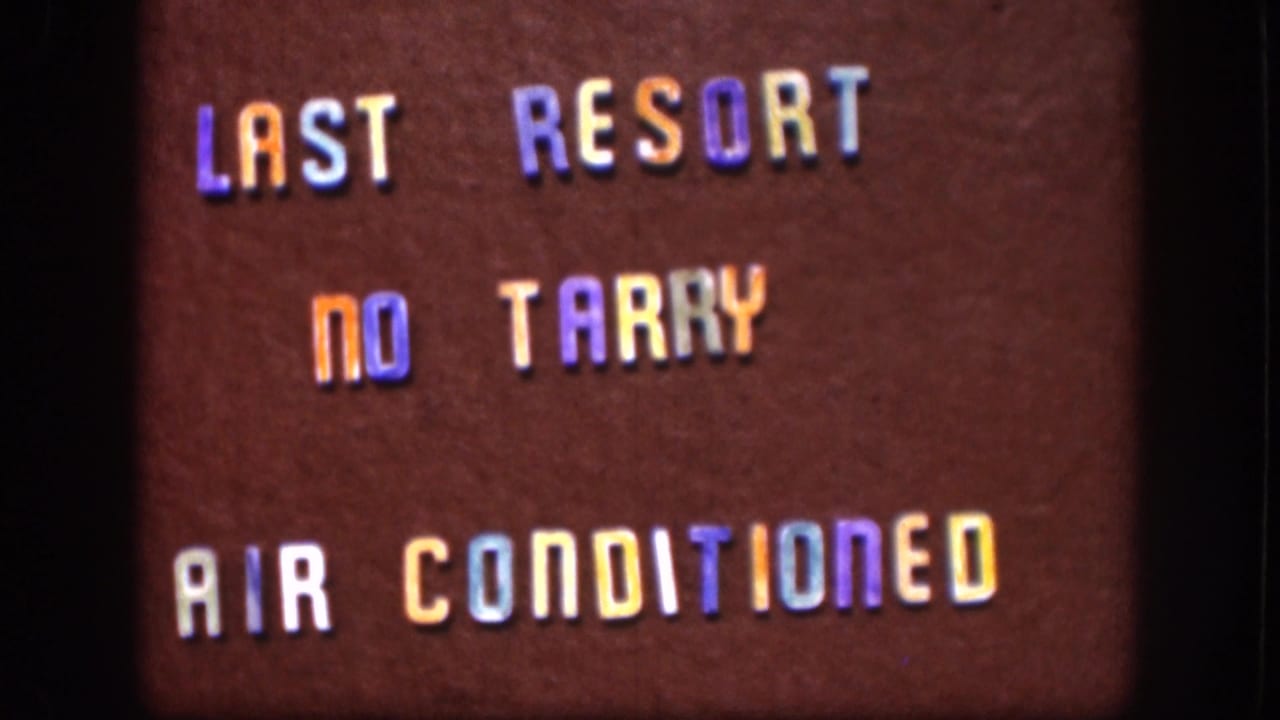 1958 8mm title card clearly reading LAST RESORT, NO TARRY, AIR CONDITIONED in multicolored letters.