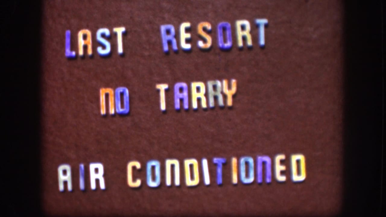 Final 1958 Kansas frame of the maroon lettered sign, with "LAST RESORT," "NO TARRY," and "AIR CONDITIONED" visible.