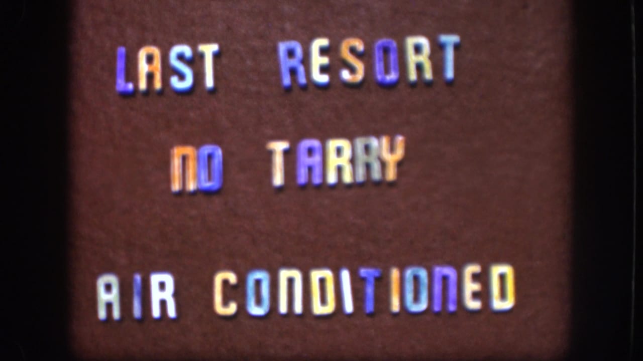 1958 Kansas 8mm frame repeats the hand-lettered Last Resort sign against a brown background with visible film edge.
