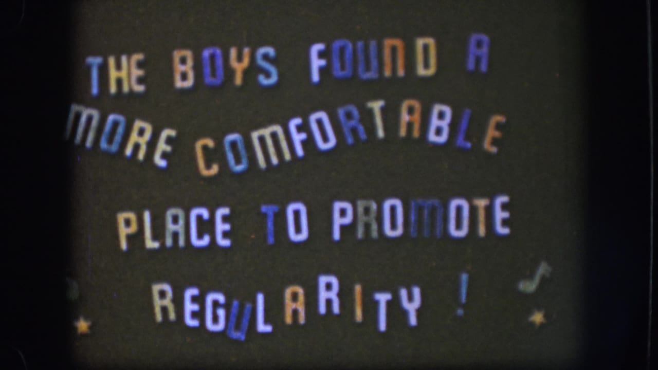 1958 Kansas home-movie frame of the same playful title card, with orange, blue, purple, and white letters on black.