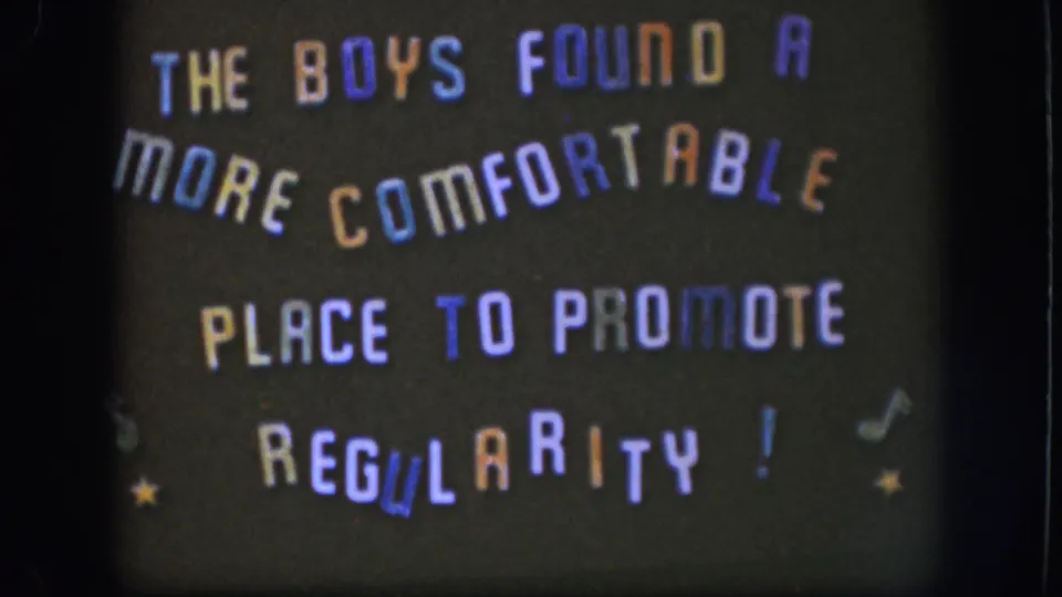 1958 Kansas 8mm still with the humorous regularity message filmed slightly soft and framed by dark film borders.