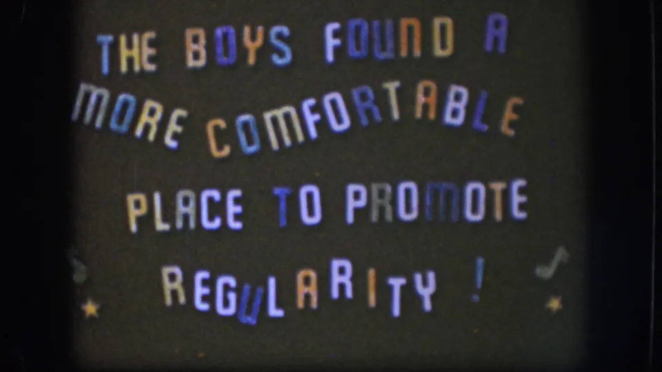 Final 1958 Kansas frame showing the static dark title card with playful multicolored lettering and decorative symbols.