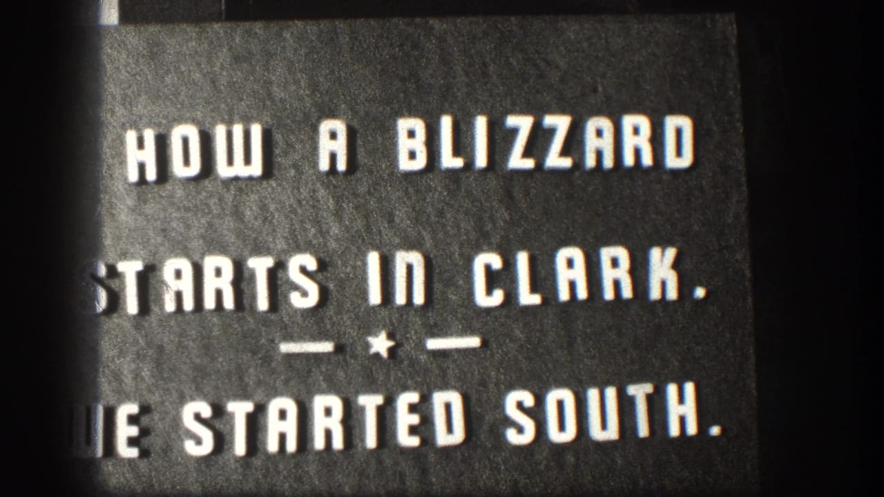 Black title card with white lettering describing the blizzard in Clark and the filmmakers starting south.