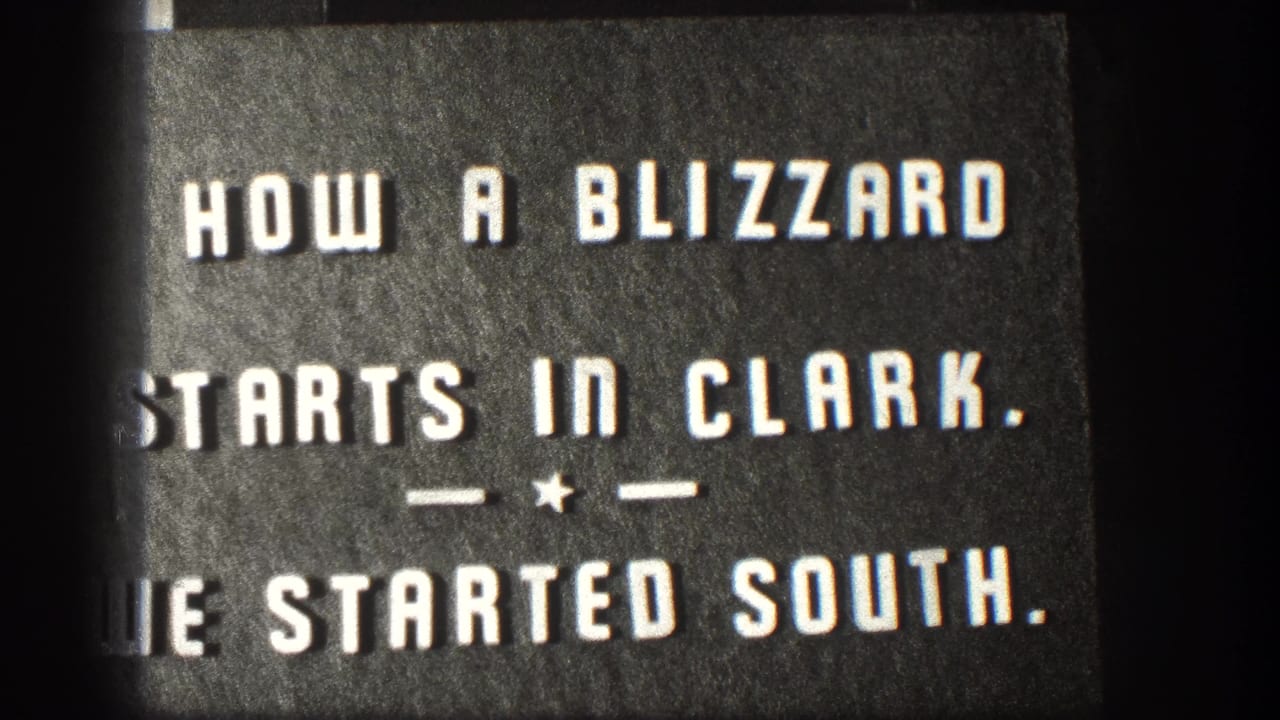 1958 Kansas 8mm title card with bold white lettering introducing how a blizzard starts in Clark and a trip south.