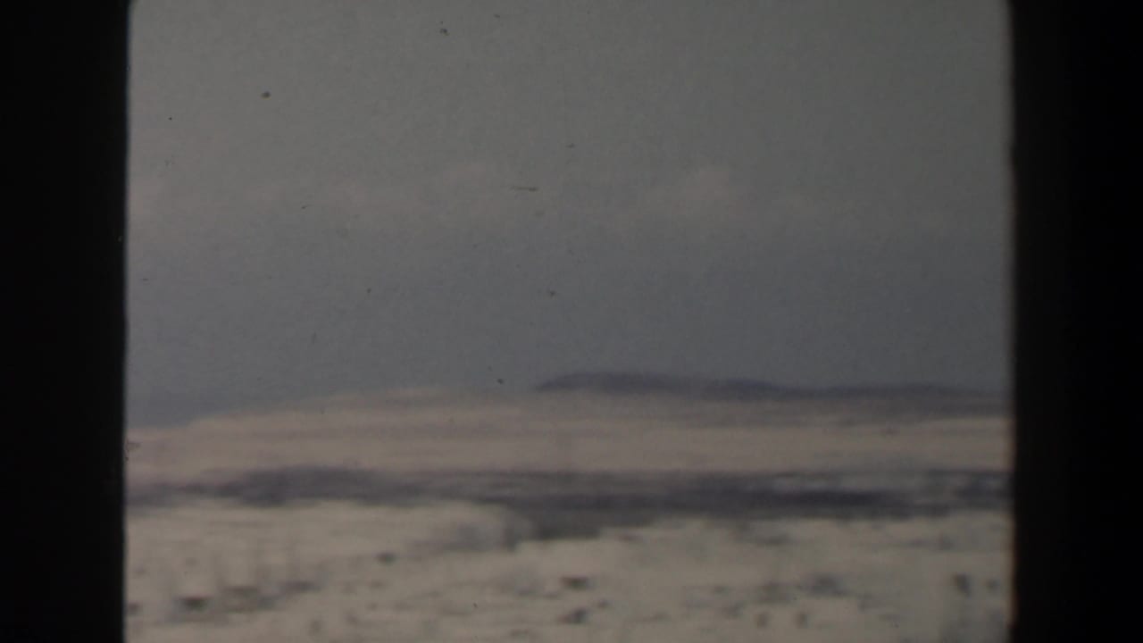 Soft distant skyline with pale buildings and horizon line.