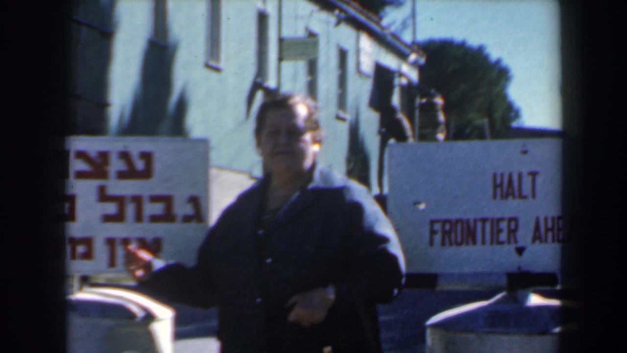 A woman stands beside Hebrew sign text and an English HALT FRONTIER AHEAD warning in a 1960s Israel roadside scene.