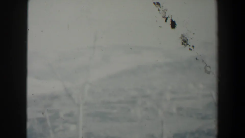 1960 Israel 8mm view with distant hazy terrain and faint branches divided by a dark window-like vertical bar.