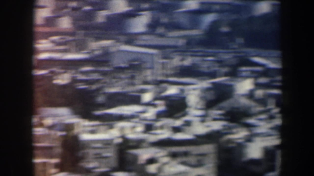 1960 Israel home-movie frame showing a soft, elevated view over dense low-rise buildings and rooftops.