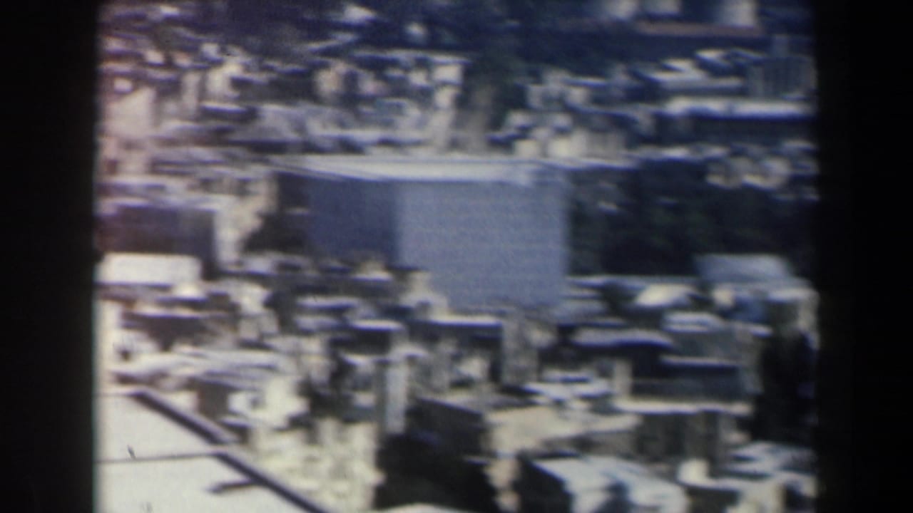 Dense city buildings seen from above with a large block-like structure.