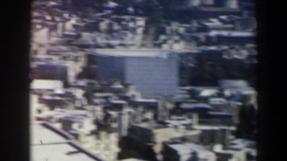 1960 Israel frame with low-rise buildings, a larger rectangular structure, and narrow urban gaps seen from above.