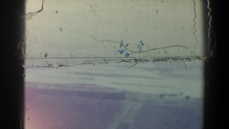 Pale hazy sky and distant horizon in 1960 Israel footage, with visible scratches, dust, and dark film-frame borders.