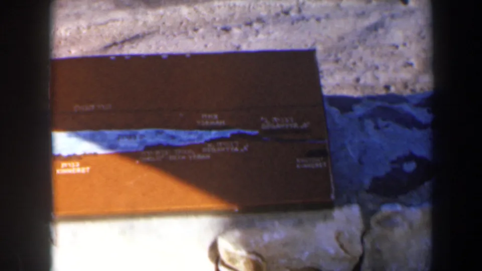 1960 Israel frame with the brown regional plaque, Hebrew and English lettering, blue route line, and rough stone setting.