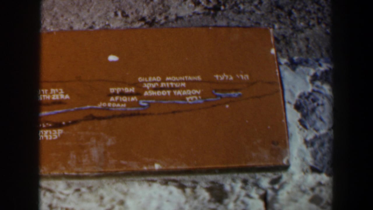 Closer view of the orange plaque with lettering and a dark vertical film edge.