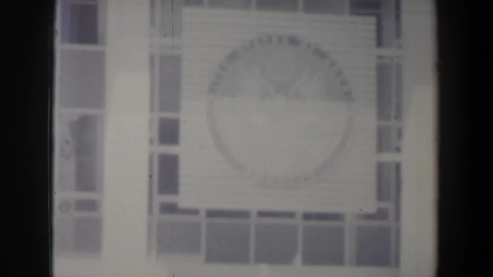 Israel 1960 8mm frame showing a soft facade detail with windows and a circular decorative element on the wall.