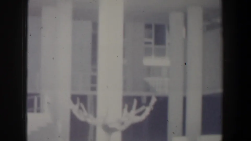 Soft final frame from the Israel street clip showing white columns, windows, and indistinct architectural detail.