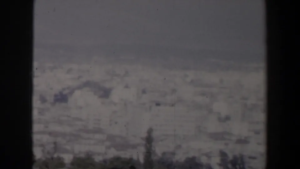 1960 Israel frame with a blurred coastal skyline, sea horizon, subdued sky, and heavy dark film borders.