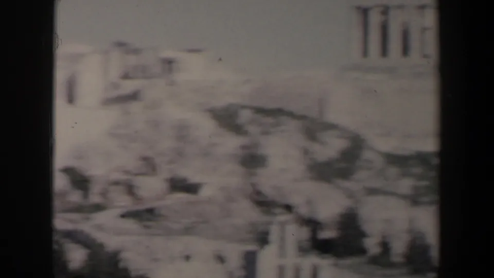 1960 Israel frame showing weathered stone structures and column-like forms, possibly ruins or temple architecture.