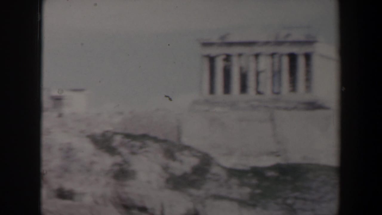 Columned ancient-looking structure above a rocky slope.