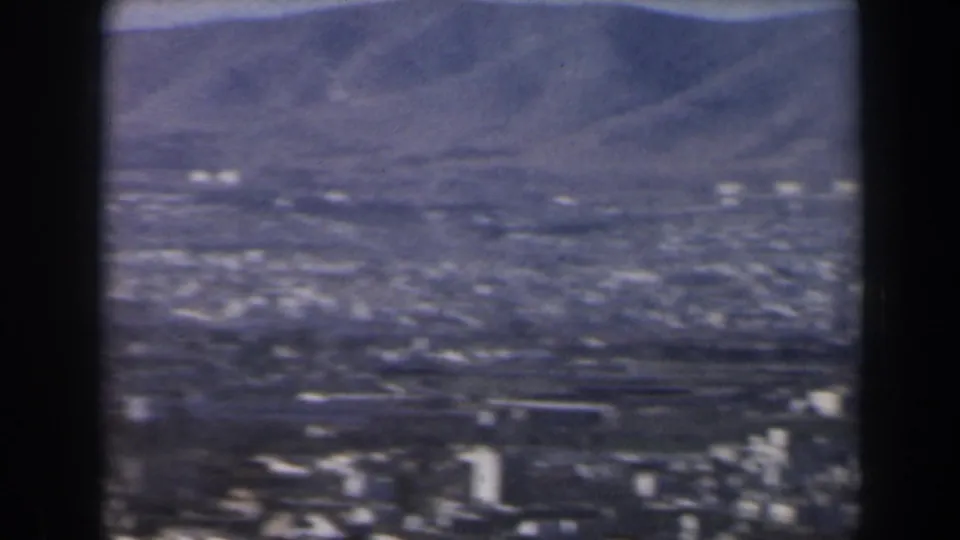 1960 Israel aerial or elevated view across a dense cityscape toward mountains, with taller buildings near the lower frame.