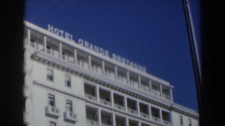 1960 Israel 8mm frame with HOTEL GRANDE BRETAGNE lettering on the roofline above balconies and windows.