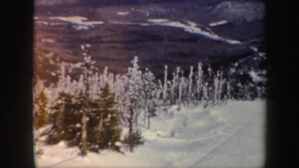 A snowy Vermont overlook frames frosted trees and a valley below, with 8mm color shift and dark frame edges visible.
