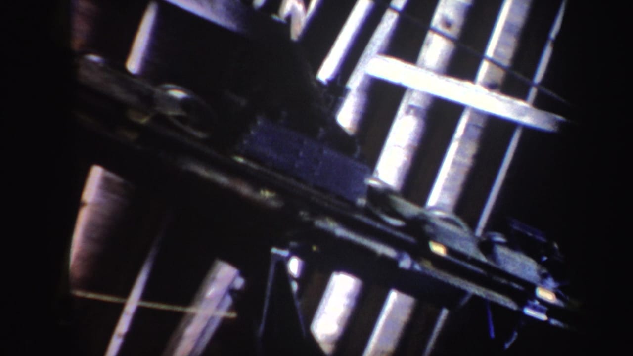 Close view of metal ski-area equipment against a dark background.
