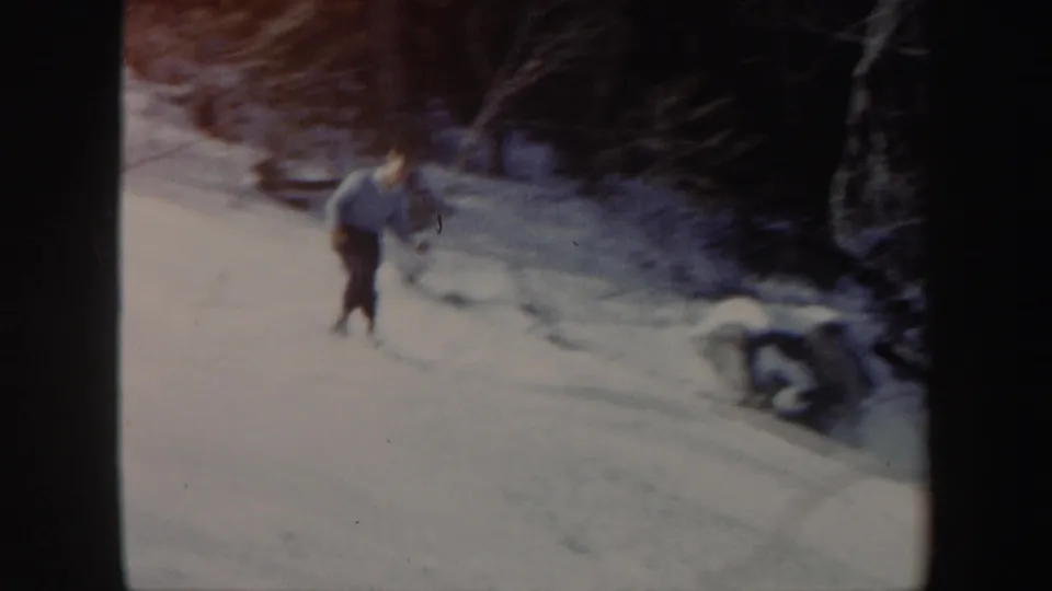 Near the end of the clip, the Vermont skier leans forward while descending past snowbanks and winter trees.