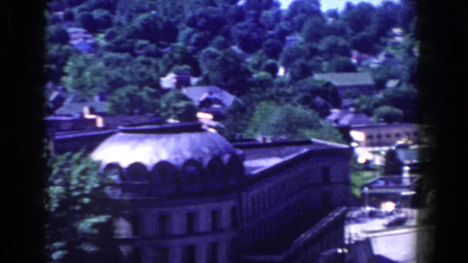 Elevated 1958 French Lick view showing a large domed roof, town buildings, and wooded slopes.