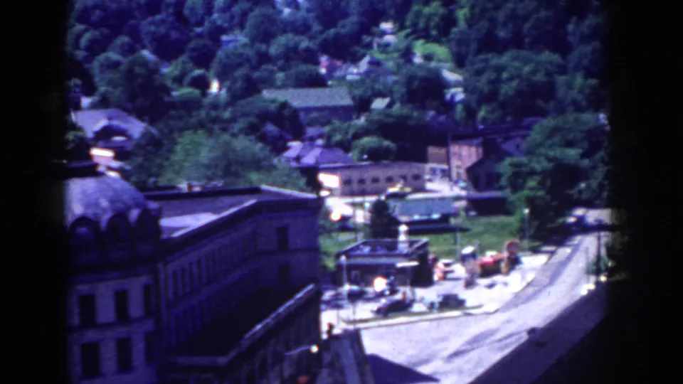 French Lick, Indiana in 1958, viewed from above with a road, rooftops, trees, and a domed building.