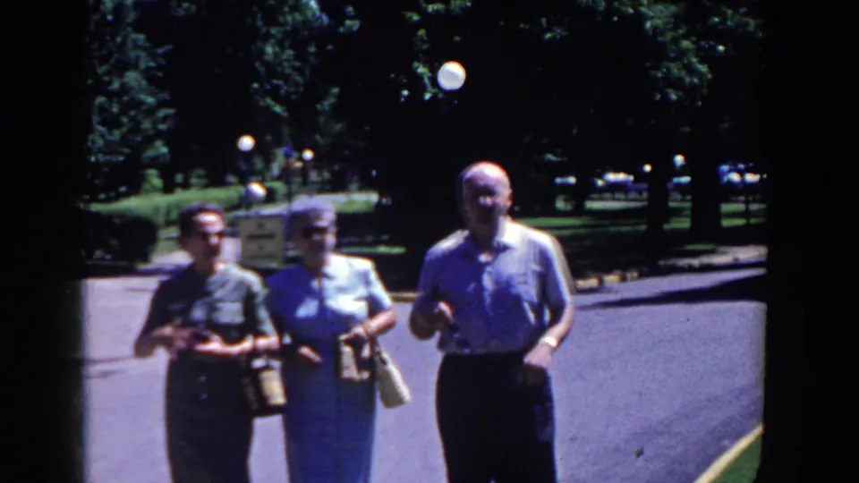 The group nears the camera in the 1958 French Lick footage, with the man at right and two women beside him carrying handbags.