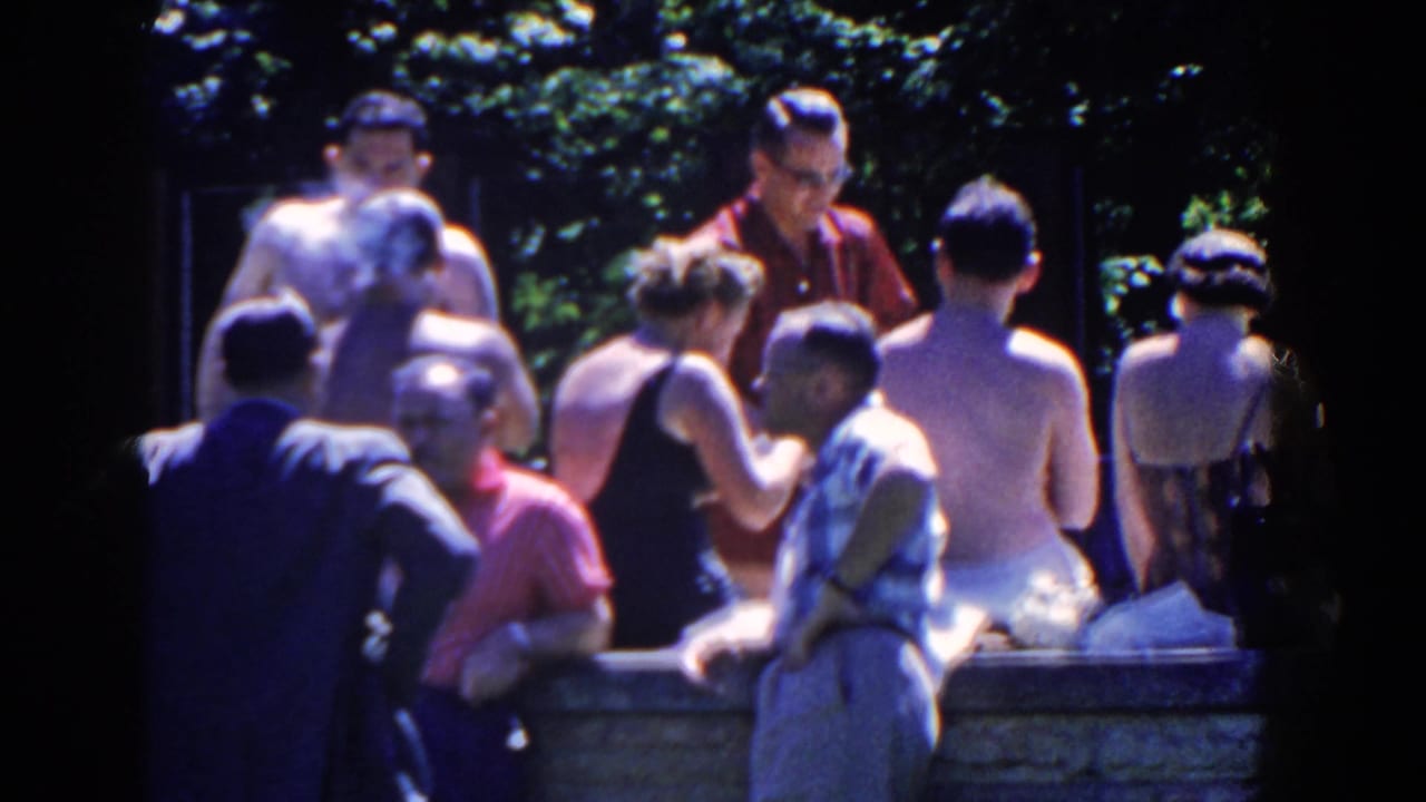 Adults in midcentury swimwear and casual clothing cluster around the stone pool edge at French Lick in 1958.