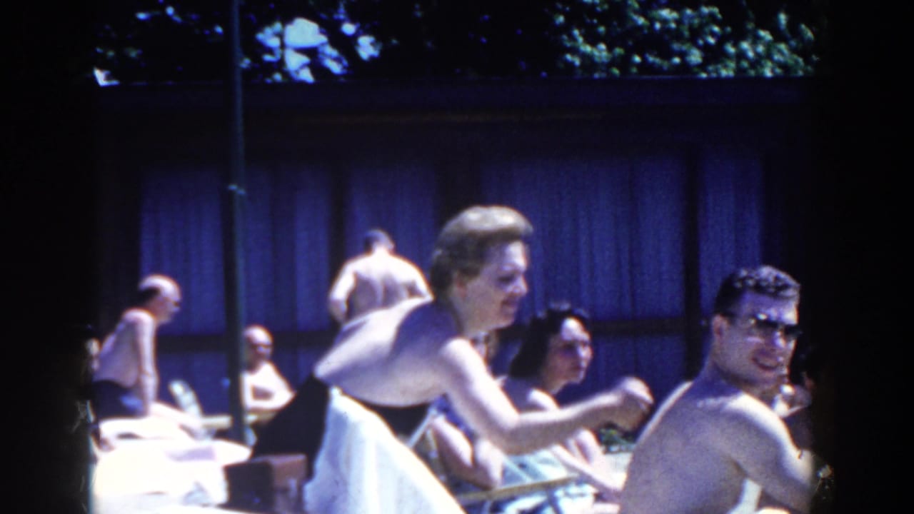 Poolside adults in 1958 French Lick footage sit and lean in swimwear, with a smiling man in sunglasses facing the camera.
