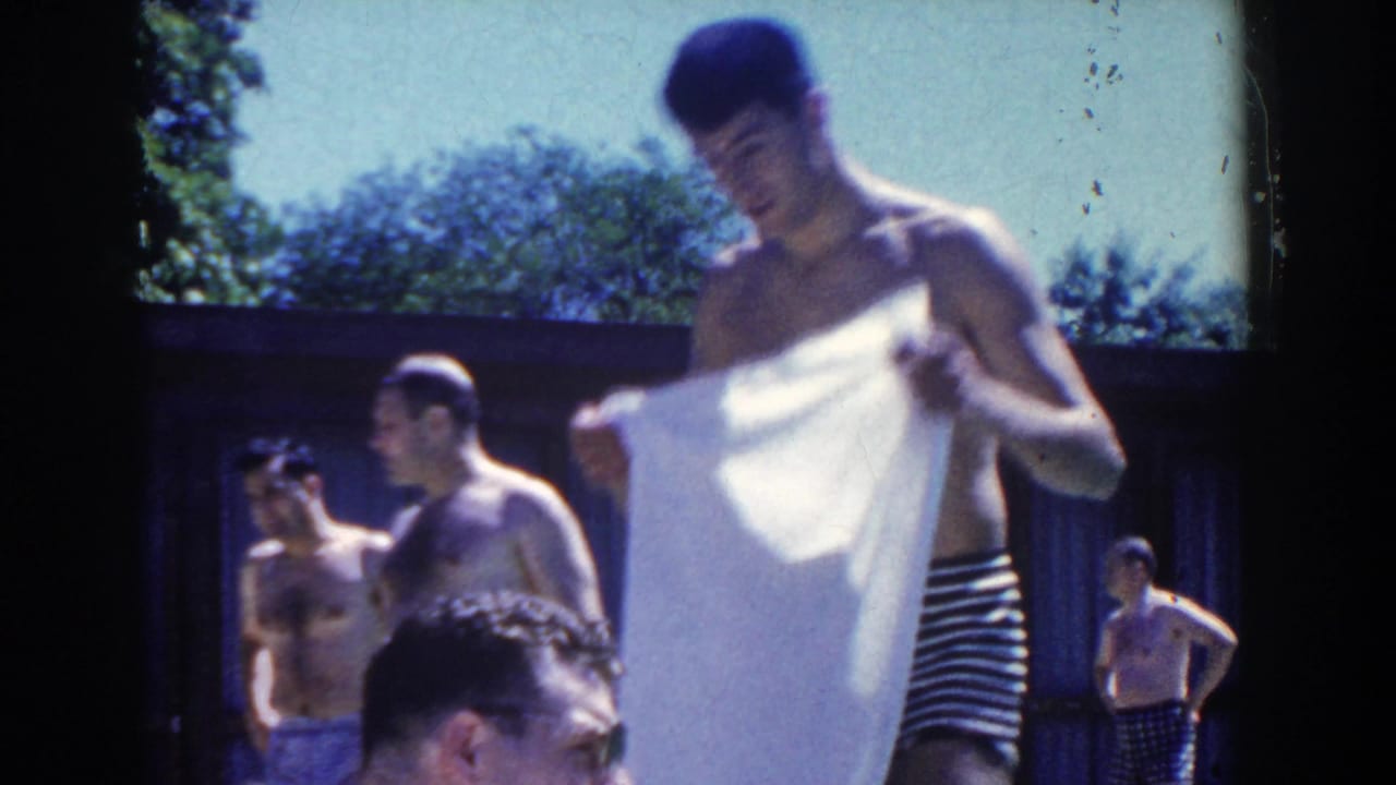A man dries or unfolds a white towel beside other swimmers at a 1958 French Lick pool gathering.