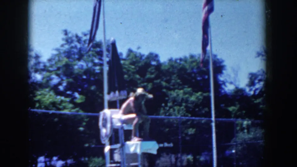 A wider 1958 poolside view shows a person near a high chair, fence, trees, flagpoles, and the pool edge.