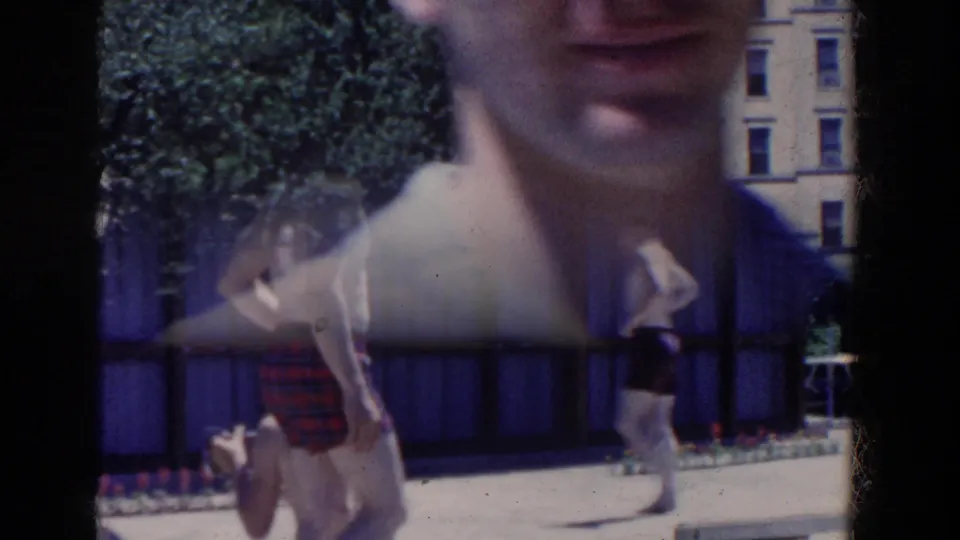 Close passerby view of an adult man in casual 1950s clothing on the French Lick hotel grounds.