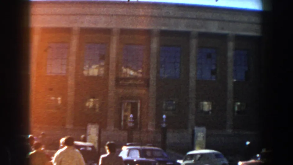 1959 Casablanca street footage showing cars, pedestrians, tall pillars, large windows, and warm 8mm color fading.