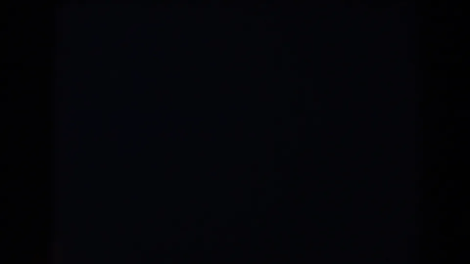 Very dark 1958 Las Vegas-labeled 8mm frame with a faint gray patch and indistinct shadow detail.