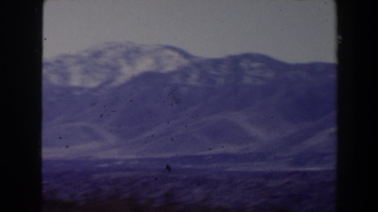 Soft hazy view of distant desert mountains with dark 8mm frame edges.