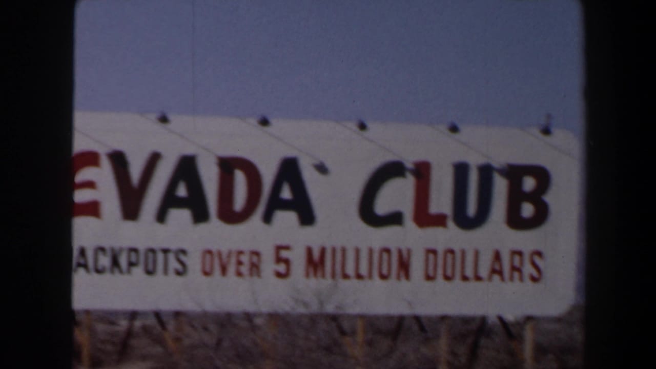 A Nevada Club sign with jackpot wording appears beside the road in 1958 Las Vegas home-movie footage.